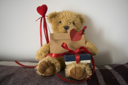 Toy bear with a letter on plaidの写真素材