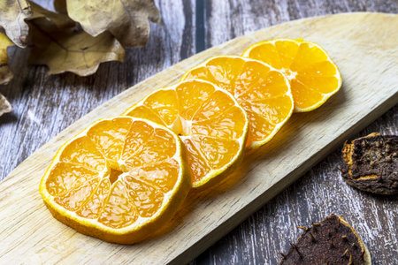 Sliced ââtangerine on wood in the autumn season.の写真素材