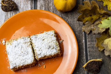 Apple pie sprinkled with sugar on a plate in the autumn season.の写真素材