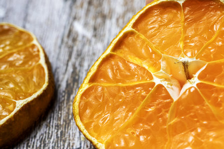 Mandarin slices on a wooden table.の写真素材