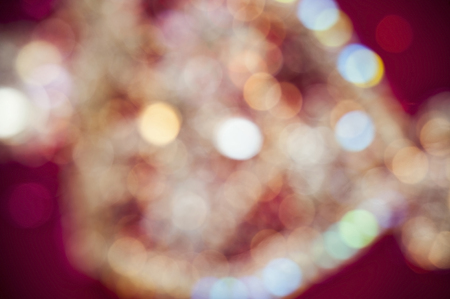 Blurred background. Asian pattern with precious stones on red fabricの写真素材