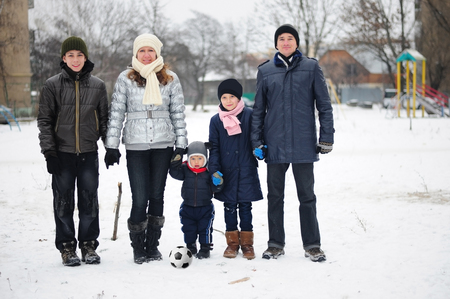 Happy family of five people are photographed in the winter.の写真素材