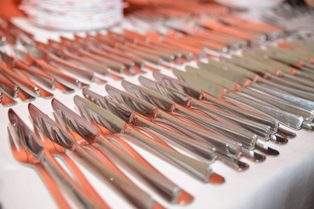 Stainless steel cutlery laid out on the tableの写真素材