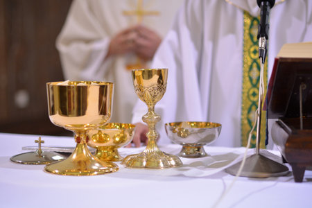 gilded chalices and bowls during a service on the altarの写真素材