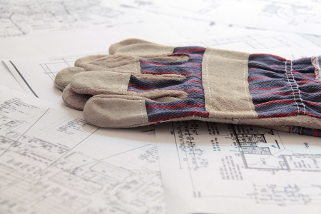 gloves on blueprintsの写真素材