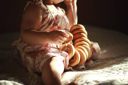 Baby girl playing with yummy donutの写真素材