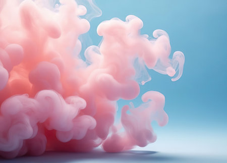 Elegant pink liquid explosion with dreamy smoke effect on pastel blue.の写真素材