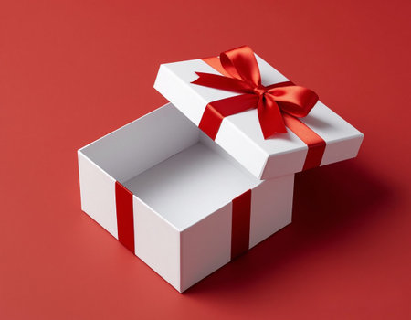 Minimalist Open Gift Box with Red Bow on Red Background, Copy Space for Designの写真素材