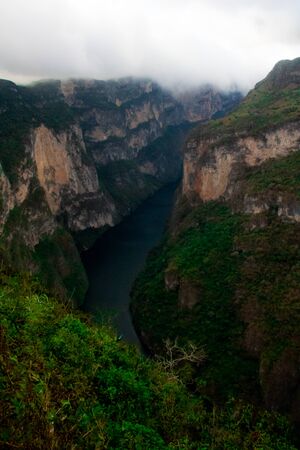 Aerial view of the Sumidero Canyon in Chiapas, Mexico. View of the river between the mountains with native plants and the cloudy skyの写真素材