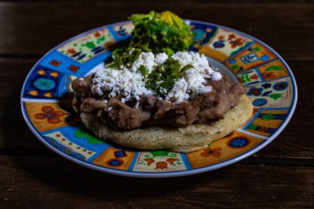 Gorditas, typical regional Mexican food. Tortilla dough with beans, cheese, cream, guacamole and sauceの写真素材