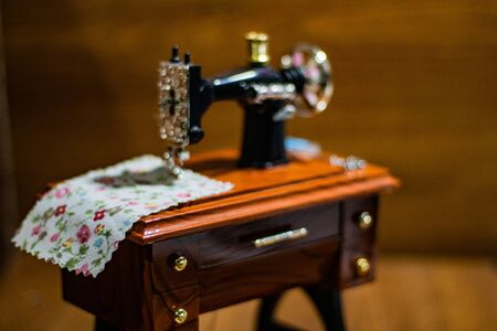 Mini sewing machine with multi-colored threads around itMini sewing machine with multi-colored...