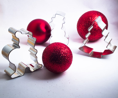 christmas decoration with three red balls and figures on white backgroundの写真素材