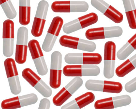 Red and White Capsules splattered over a white background.