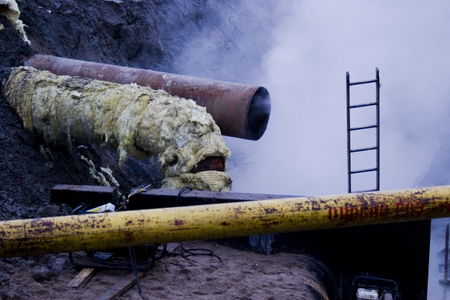 Pipes of communications in isolation and steam coming from itの写真素材
