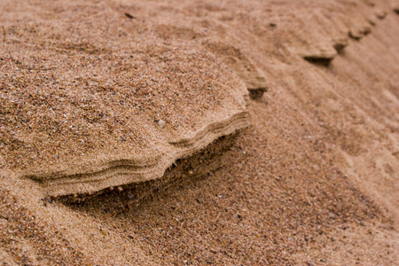 Ledge of sand with coarse grains of sandの写真素材