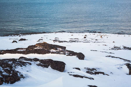 North sea coast with ice and snow. Tranquil frozen natural landscape. Horizontal photo with copy space. Banner for website header designの写真素材