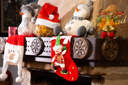 Christmas decorations with dolls and socks in the fireplace
