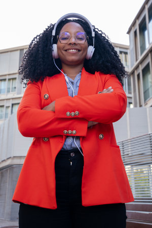Vertical Single close up of smiling African American businesswoman standing looking at camera with...