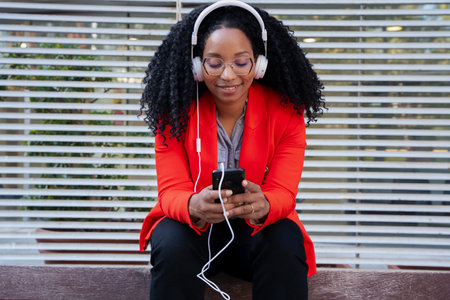 Portrait close up Happy african american business woman sitting browsing the internet on a...