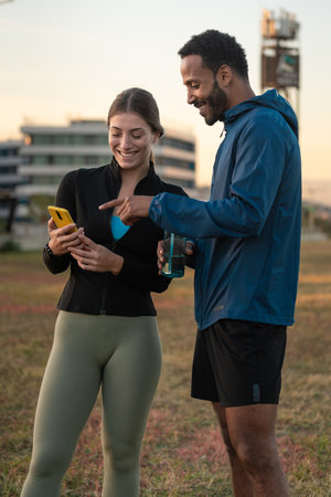 Young athletes using apps on the phone to keep track of their exercise routine.