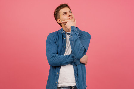 Portrait Thoughtful young man on pink background