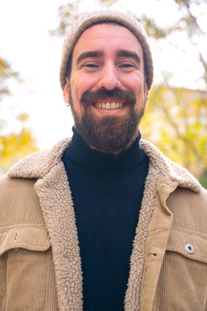 Vertical portrait young caucasian smiling man with outdoors.