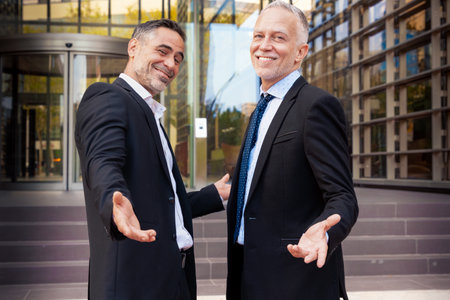 Portrait smiling two attractive and self-confident businessmen looking at cameraの写真素材