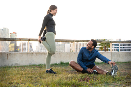 Young smiling sporty couple doing stretching.
