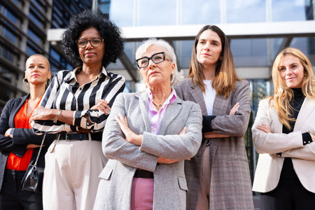 Four multiracial business women posing smiling for the camera.の写真素材