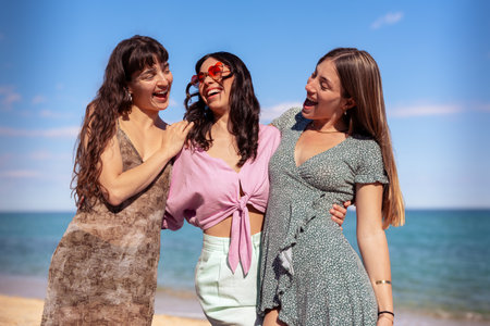 Portrait of three female friends a on the beach having fun.の写真素材