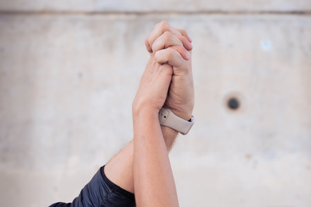 Unrecognizable couple holding hands outdoors