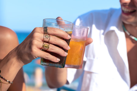 Happy young couple on vacation,drinking in restaurantの写真素材
