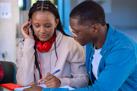 African american happy teenage students talking with university notes. and smartphones