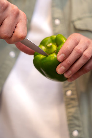Slicing a Green Bell Pepper with Precisionの写真素材
