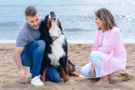 Happy couple with their dog enjoying a fun and relaxed day together at the beach
