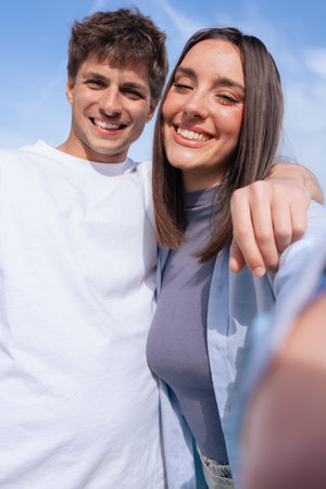 Young couple smiling outdoors posing for selfie together lifestyle momentの写真素材