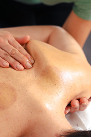 Woman receiving relaxing back massage at spa wellness therapy sessionの写真素材