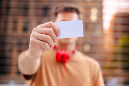 Man showing blank card to camera focus on business identity conceptの写真素材