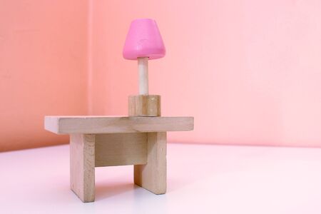 Wooden toy table and lamp on the white floorの写真素材
