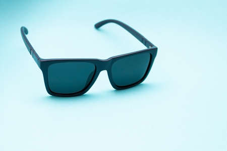 Black sunglasses on blue backgroundの写真素材