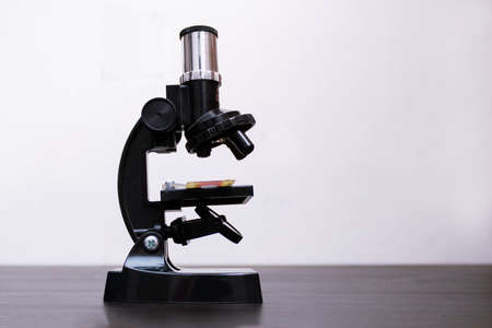 Small black simple microscope on the table