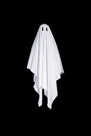 White ghost with black eyes, made from bedsheet. Isolated on black background.の写真素材