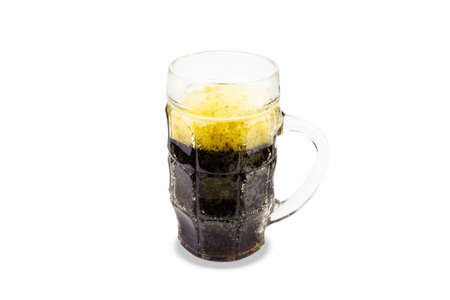Glass mug of dark beer with yellow foam. Isolated on white background.の写真素材