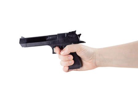 Fair-skinned woman's hand holding black gun. Isolated on white background.の写真素材