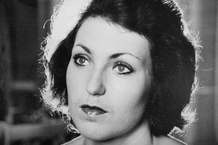 Vintage black and white portrait of a woman, close-up. Early 1980s. Old surface, soft focus....