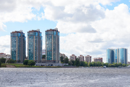 Landscape with bay, three high buildings and sky with white cumulus clouds - Neva River, Russia, Saint Petersburg, July 2021のeditorial素材