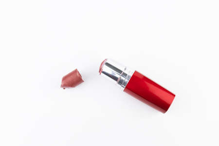 Broken red lipstick and tube on white backgroundの写真素材