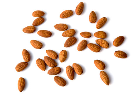 Raw Natural Organic Almonds Nuts Scattered Isolated on White Background Top View Healthy Food for Life Natural Light Selective Focusの写真素材