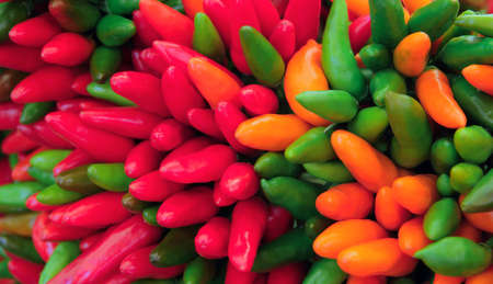 bunch of bright colorful hot chili peppers closeupの写真素材