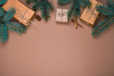 Christmas presents in kraft paper with pinetree branchesの写真素材